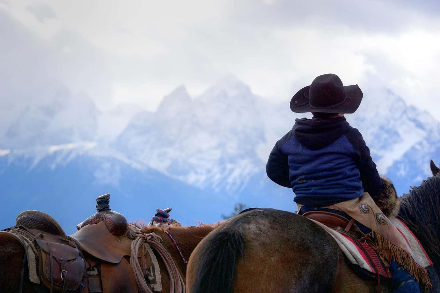 Young Tŝilhqot'in rider looks towards the mountains from the Nemiah valley. Photo: Max Nishima.