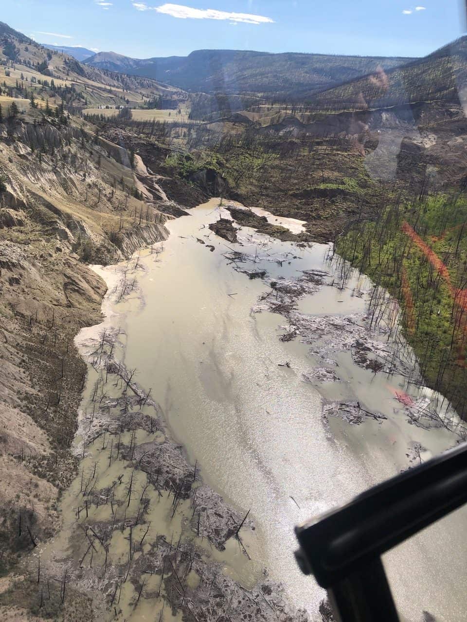 Dam and impoundment – Upstream lake (impoundment) forming above the full blockage, with extensive sloughing of hillslopes and accumulation of wood/debris into temporary lake, that over 6 days extended approx. 11km upstream (July 31, 2024).